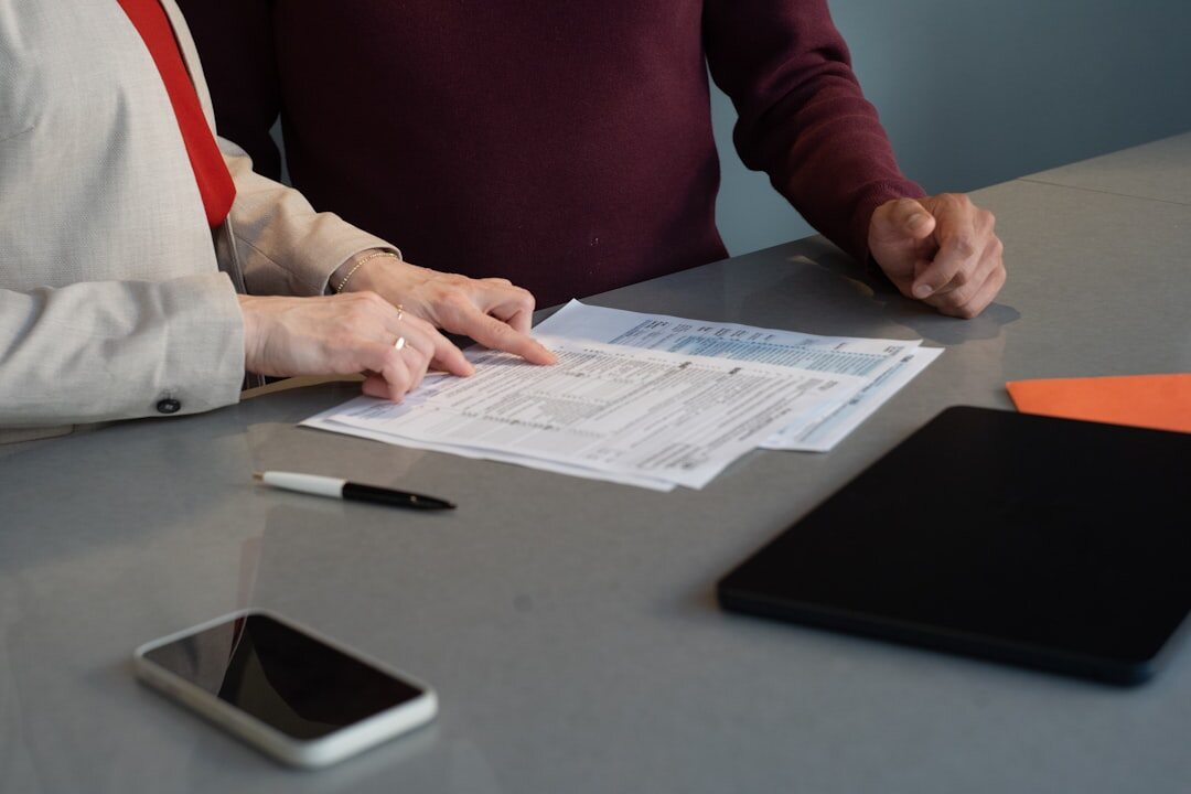 Legal advisor discussing inheritance documents with clients at a desk